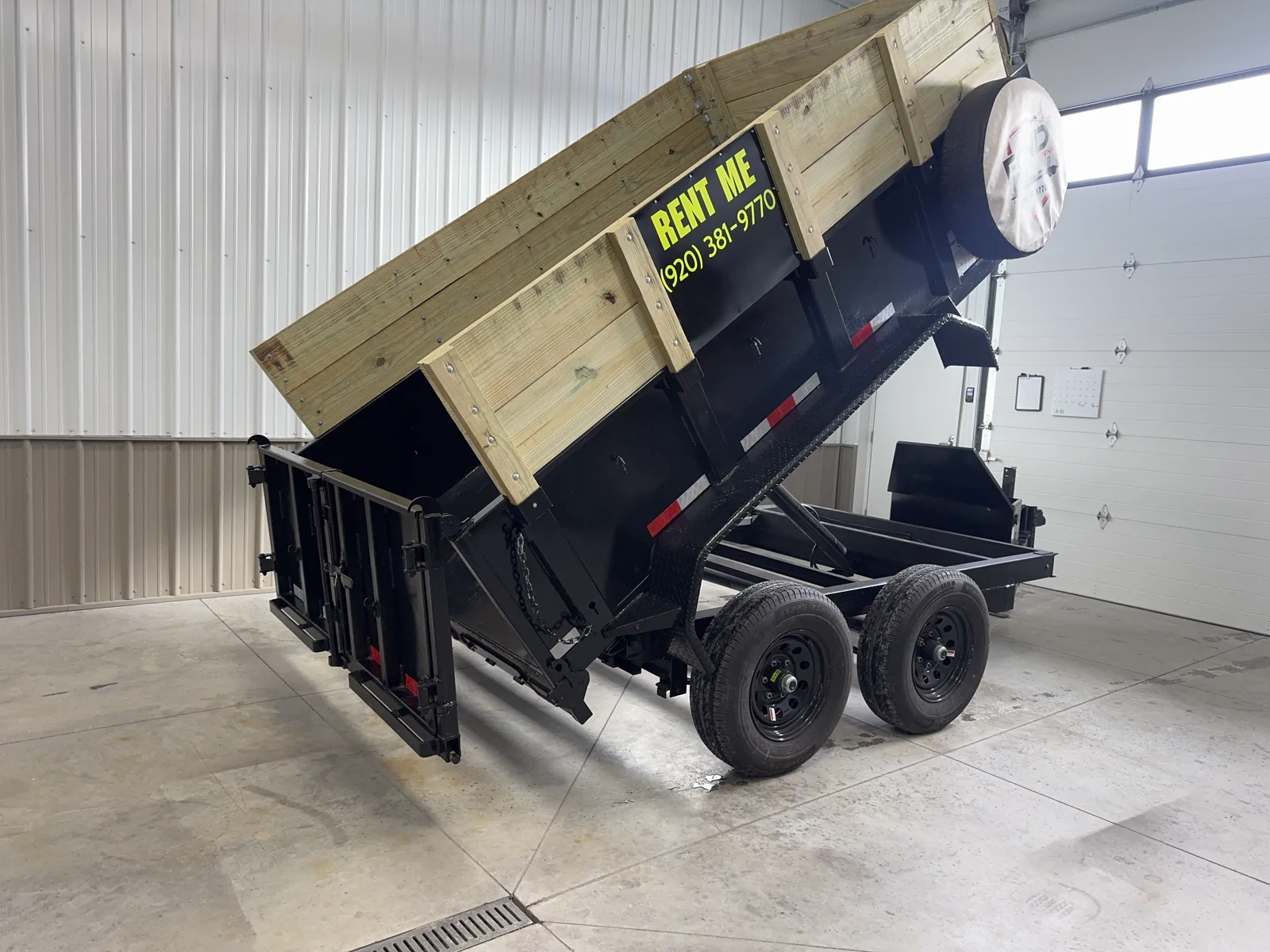 Dump trailer with side extensions and the bed raised, Fond du Lac, Wisconsin