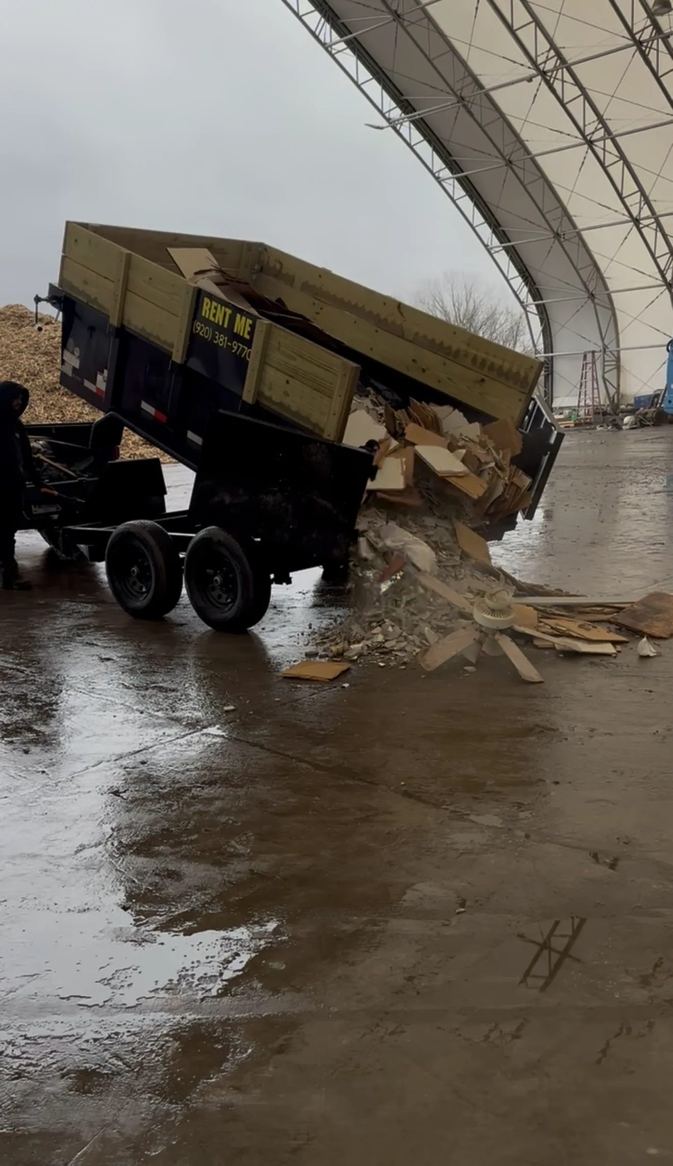 Dump trailer tipping a load of lumber debris at a disposal facility in Wisconsin